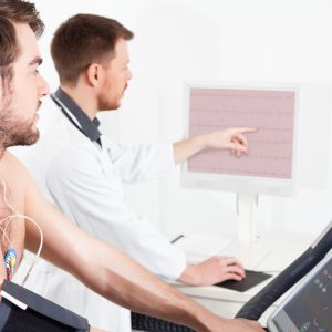 Doctor shows the patient the ECG recording of the electrical activity of the heart